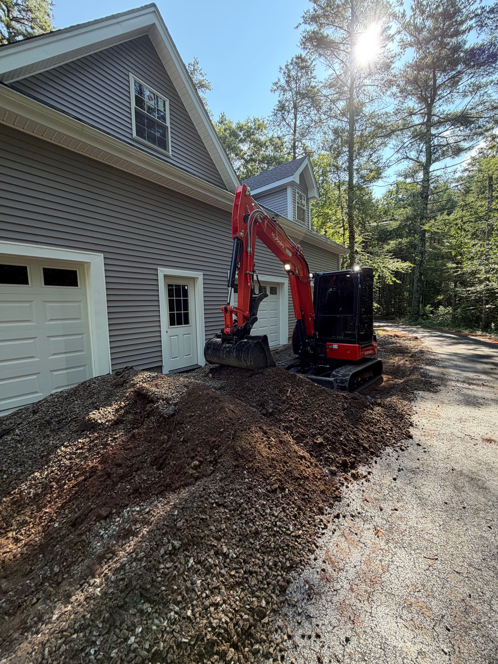 Garage Apron Regrind and Stone Wall Fixes a Drainage Problem image